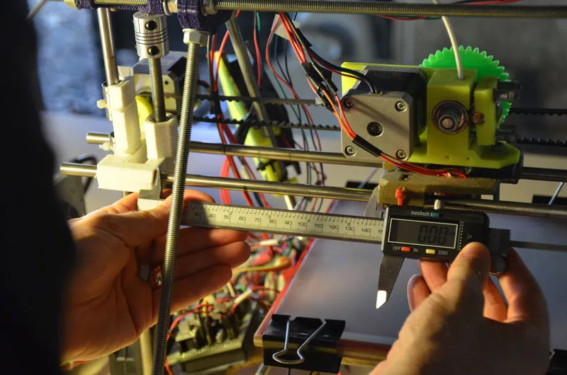 A photo of a callipers being used to measure the x-axis on a 3D printer